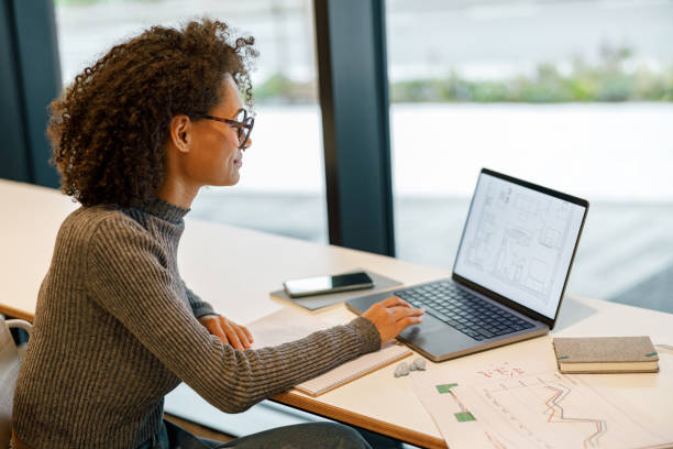 istock Smiling afro american woman student studying online while sitting in cozy cafe 1447892992