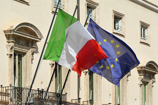 Two large waving flags of ITALY and EUROPEAN UNION
