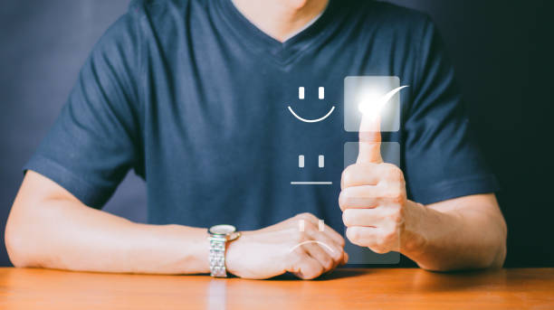 istock Customer Service and Satisfaction Concept Businessman is touching the virtual screen on the happy Smiley face icon to satisfy the service. Rating Very impressed. 1447894802