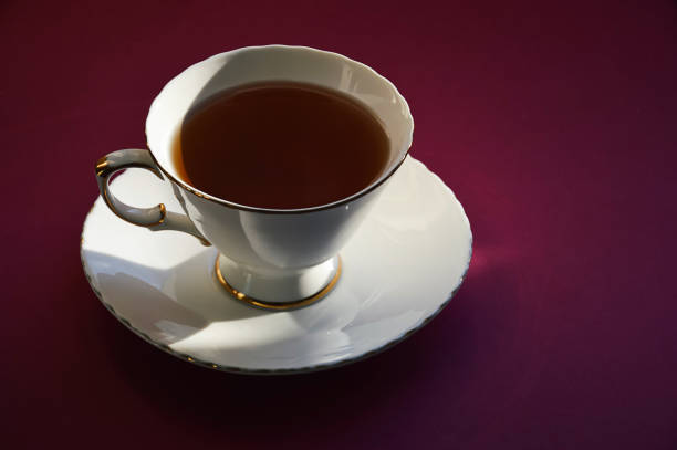 istock a white mug with tea on a saucer. background for the design. 1447897236