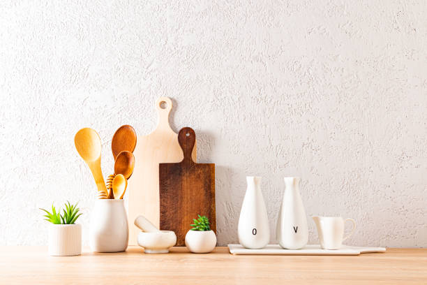istock Beautiful modern background kitchen countertop with various kitchen utensils for cooking and indoor plants in ceramic mini pots. 1447897734
