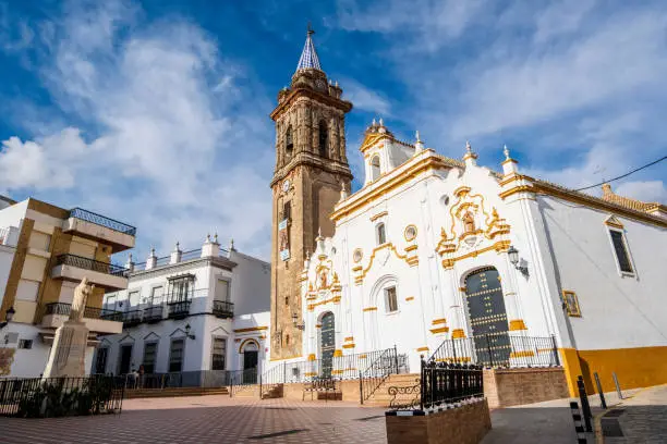 Photo of Charming Andalusian square with church in small town, Bullullos Par del Condado, Spain