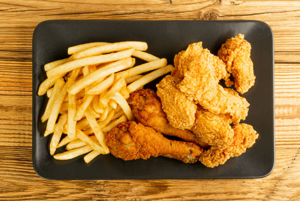 istock Breaded Fried Chicken Wings, Fingers and Drumsticks on Wooden Rustic Background Top View 1447899892