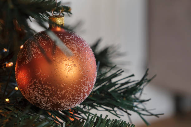 Frosted bronze colored christmas ball in a christmas tree
