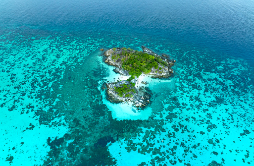 The tropical with seashore island in a coral reef ,blue and turquoise sea Amazing nature landscape with blue lagoon-Above view