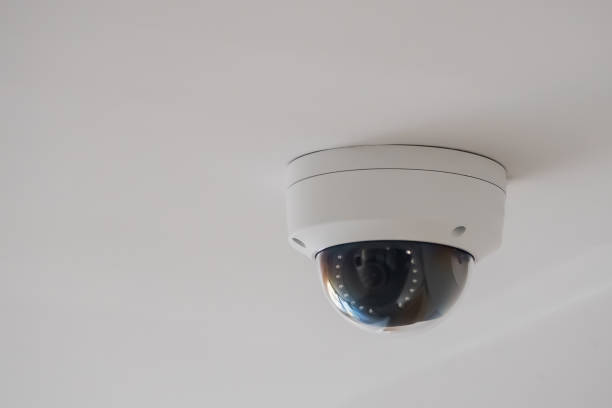 istock Security white CCTV Close up circuit television camera in the office building. CCTV in building in front of elevator. 1447904353
