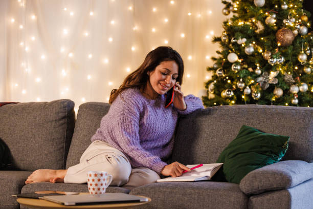 istock Woman being interrupted by a phone call while writing in a diary 1447905490