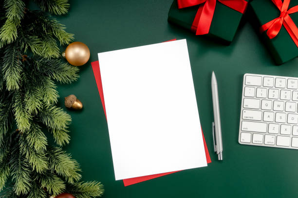 istock Mockup white notebook with pine branches and keyboard, christmas decorations on a green background 1447905877