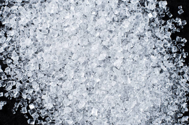 istock White salt in crystals on a dark background 1447905895
