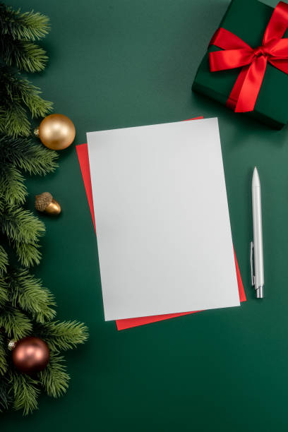 istock Notebook with pine branches and keyboard, christmas decorations on a green background. 1447905914