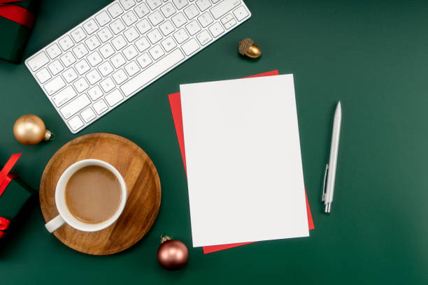 istock Home office table with Christmas decorations, coffee cup, keyboard, paper notebook. Christmas workspace. 1447905923