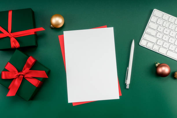 istock Home office table with Christmas decorations, keyboard, paper notebook. Christmas workspace. 1447905938