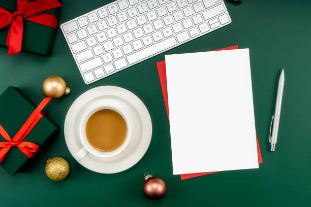 istock Home office table with Christmas decorations, coffee cup, keyboard, paper notebook. Christmas workspace. 1447905954