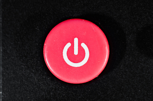 Red off button on the remote close-up, macro