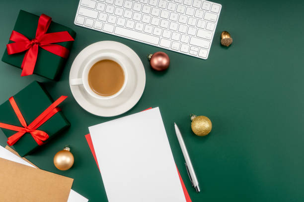 istock Home office table with Christmas decorations, coffee cup, keyboard, paper notebook. Christmas workspace. 1447906010
