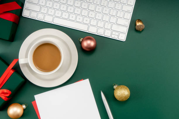 istock Home office table with Christmas decorations, coffee cup, keyboard, paper notebook. Christmas workspace. 1447906017