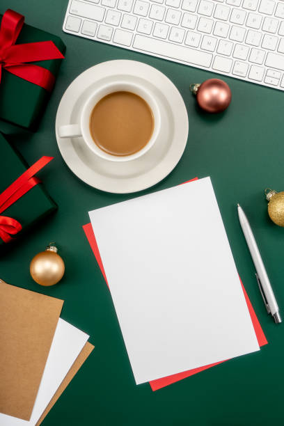 istock Home office table with Christmas decorations, coffee cup, keyboard, paper notebook. Christmas workspace. 1447906021