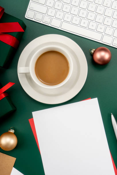 istock Home office table with Christmas decorations, coffee cup, keyboard, paper notebook. Christmas workspace. 1447906070