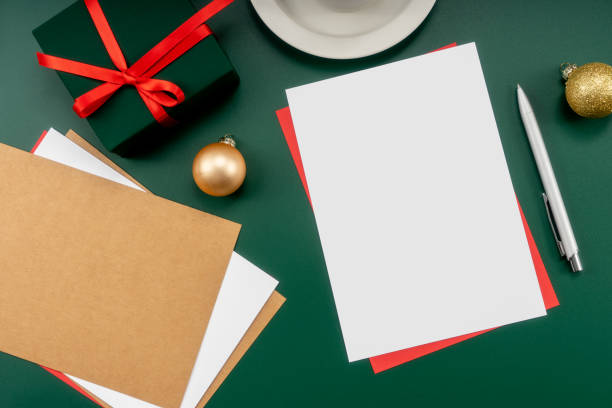 istock Home office table with Christmas decorations, coffee cup, keyboard, paper notebook. Christmas workspace. 1447906123