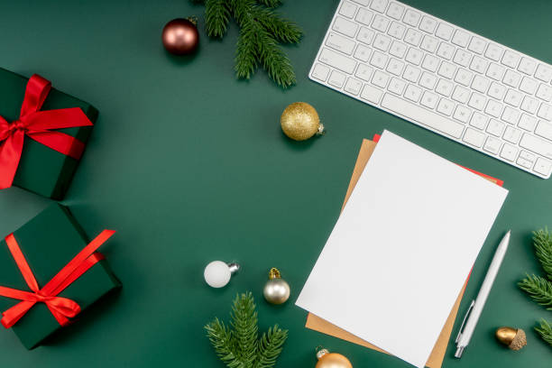 istock Home office table with Christmas decorations, keyboard, paper notebook. Christmas workspace. 1447906159
