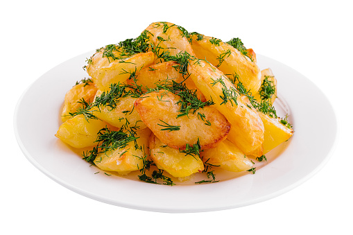 Fried potato slices with dill on plate
