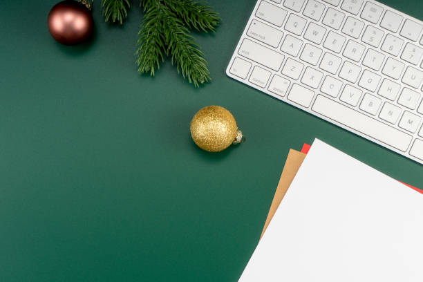 istock Home office table with Christmas decorations, keyboard, paper notebook. Christmas workspace. 1447906200
