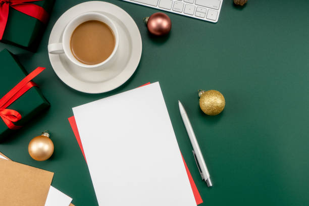 istock Home office table with Christmas decorations, coffee cup, keyboard, paper notebook. Christmas workspace. 1447906222