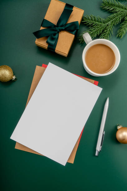 istock Home office table with Christmas decorations, coffee cup, keyboard, paper notebook. Christmas workspace. 1447906236