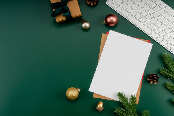 istock Home office table with Christmas decorations, keyboard, paper notebook. Christmas workspace. 1447906280