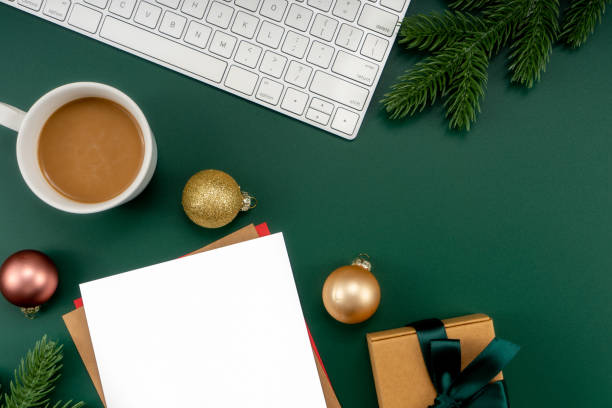 istock Home office table with Christmas decorations, coffee cup, keyboard, paper notebook. Christmas workspace. 1447906435