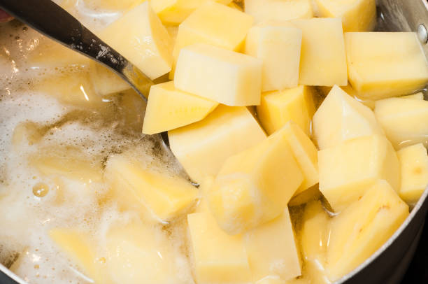 istock Raw potatoes in water before boiling foam in a saucepan 1447907312
