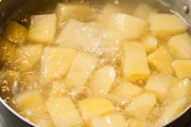 Boiling water and the process of making mashed potatoes. Bubbles of boiling liquid.