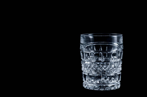 istock Faceted vintage glass on a black background, isolate. 1447907985