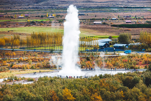 Impressive eruption of the biggest active geyser, Strokkur, with tourists waiting around, Golden circle, Iceland. Great geyser, hot springs of Iceland. High quality photo
