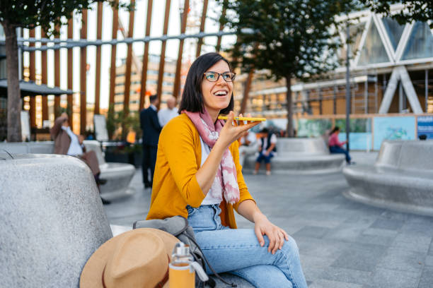 istock Young Woman Talking On The Phone While Sitting Outdoors In Milan 1447909925