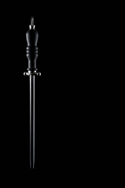 istock Sharpener for kitchen knives in the form of a rod. On a dark background, isolate 1447910386