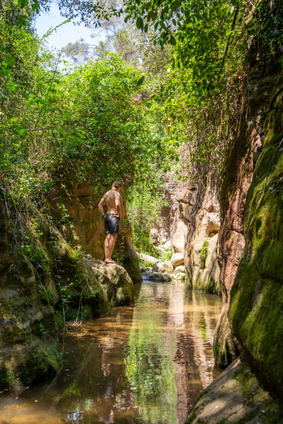 istock A boy in a river in summer. 1447910954