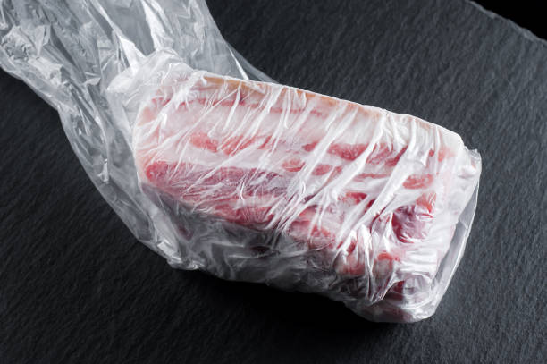 istock Ukrainian frozen fat in a plastic bag on a stone plate on a black background. Isolate 1447914189