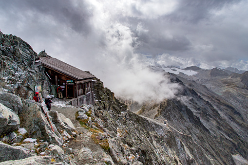 A woman is walking along the Schäfler altitude path in the Swiss alps