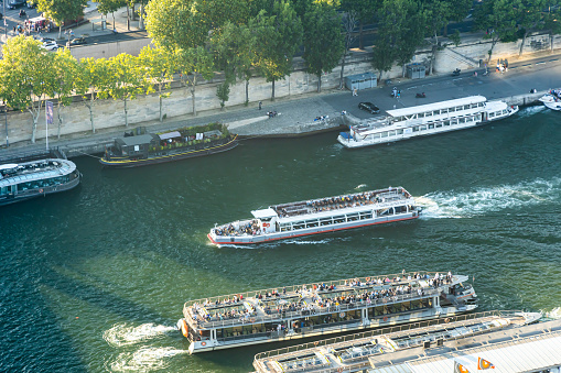 Vedettes du Pont Neuf boat full of tourists sailing on the Seine in Paris, France