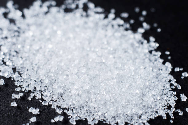 istock White refined sugar in crystals on a dark background 1447915572