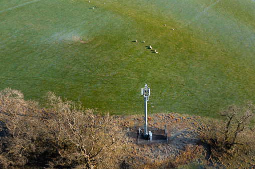 Drone view of a telecom mast in a field in Scotland on a bright sunny winter morning