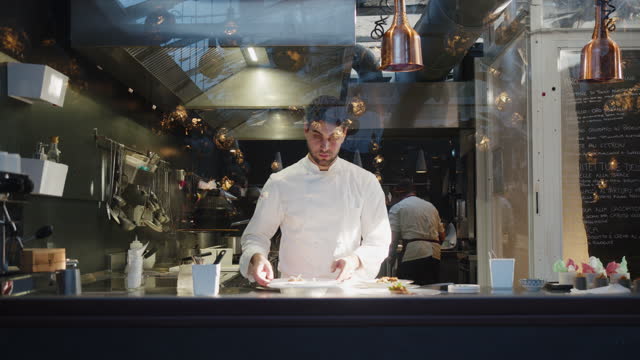 A chef is cooking in his restaurant's kitchen