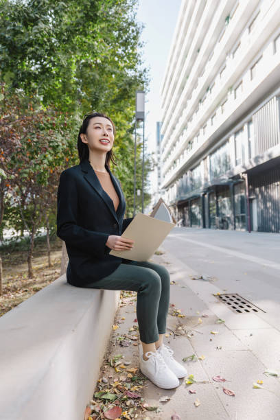 istock Successful female manager resting on the city street. 1447921020