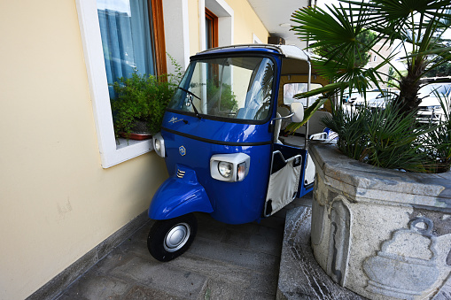 Padua, Italy- July, 05, 2022: Ape Calessino Piaggio or Vespa Car, TriVespa. Three-wheeled light commercial vehicle.