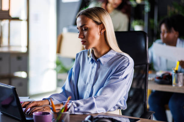 istock Diligent businesswoman typing an email at her desk 1447923620