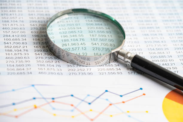 istock Magnifying glass on charts graphs paper. Financial development, Banking Account, Statistics, Investment Analytic research data economy, Stock exchange trading, Business office concept. 1447926427