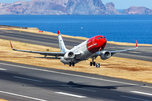 Funchal, Portugal - September 13, 2022: Norwegian Boeing 737-800 airplane at Funchal airport (FNC) in Portugal.