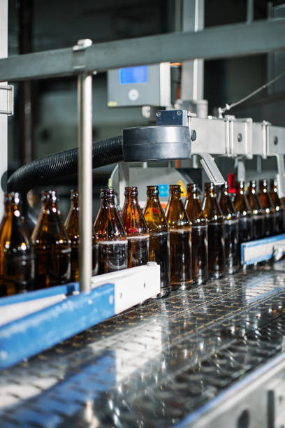 istock Close-up on a bottling machine operating at a beer factory 1447934418
