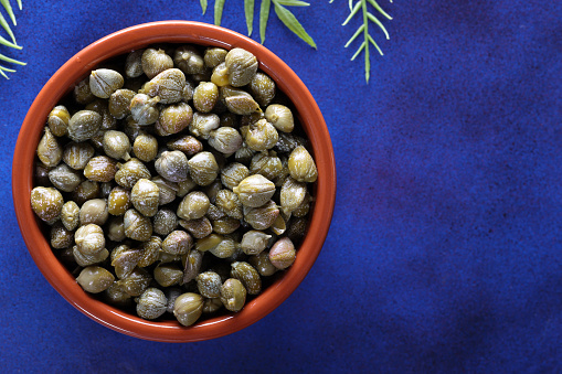 Capers on blue background